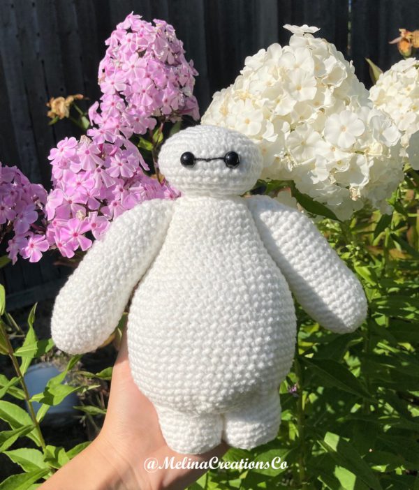 Crochet Baymax in front of flowers