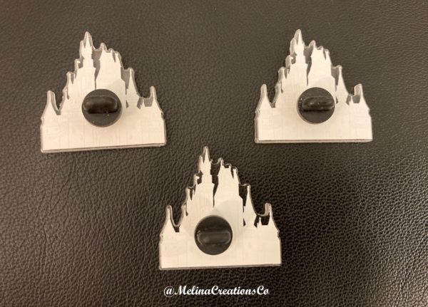 Backs of three Cinderella castle pins